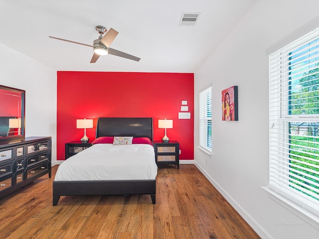 bedroom with dark wood-type flooring and ceiling fan