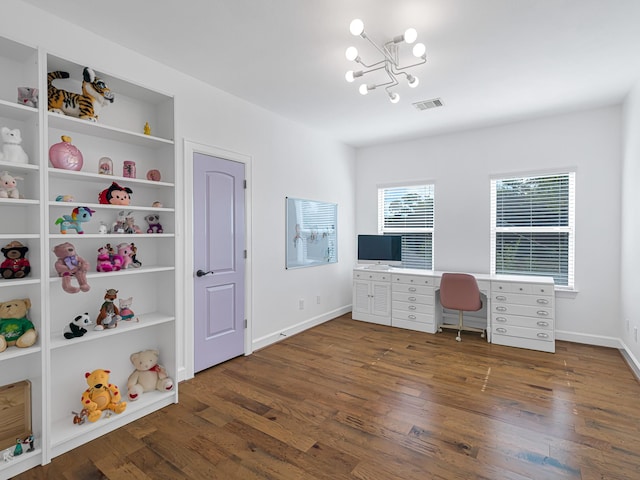 office area with an inviting chandelier, dark hardwood / wood-style flooring, and built in features