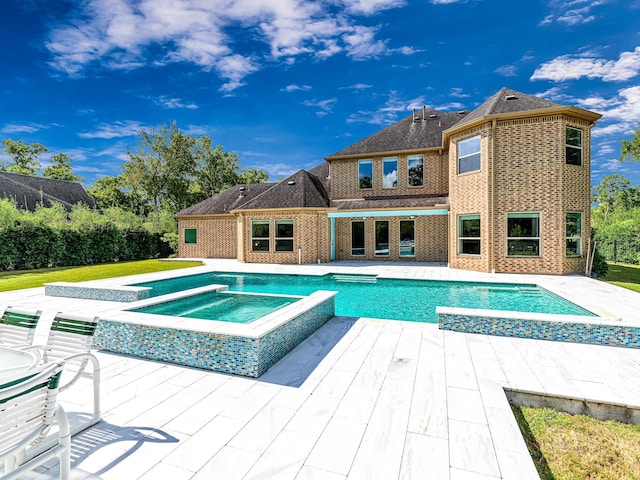 view of pool featuring an in ground hot tub and a patio area