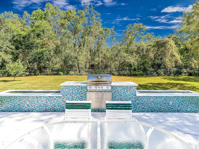 view of swimming pool featuring a grill, area for grilling, and a lawn