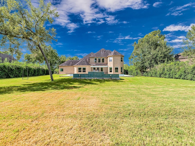 rear view of house with a yard