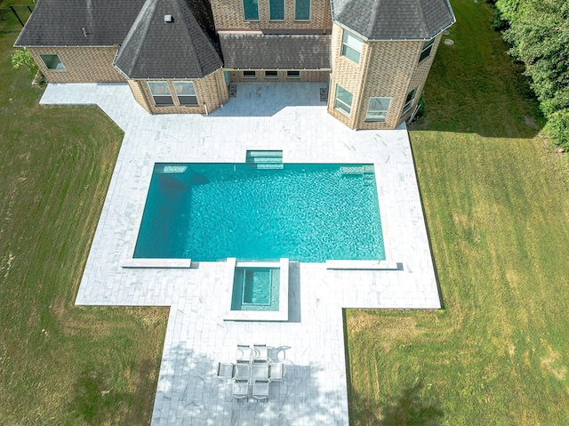 view of swimming pool with a yard and a patio area