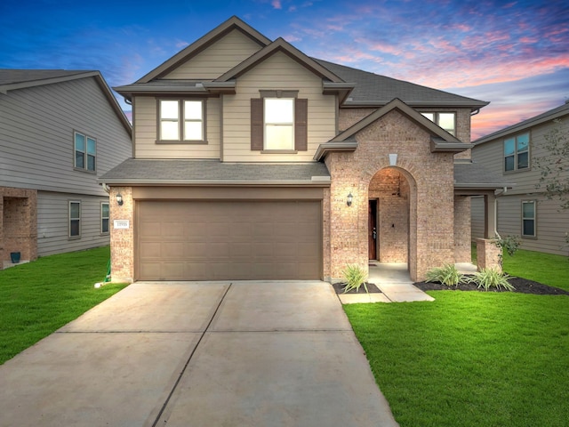 craftsman-style house featuring a garage and a lawn