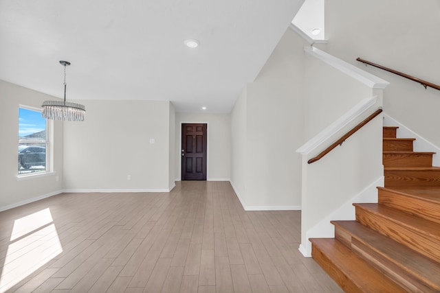 foyer featuring light hardwood / wood-style floors and a notable chandelier