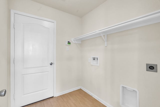 laundry area with electric dryer hookup, hookup for a washing machine, and light hardwood / wood-style flooring