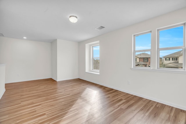 spare room with light hardwood / wood-style flooring