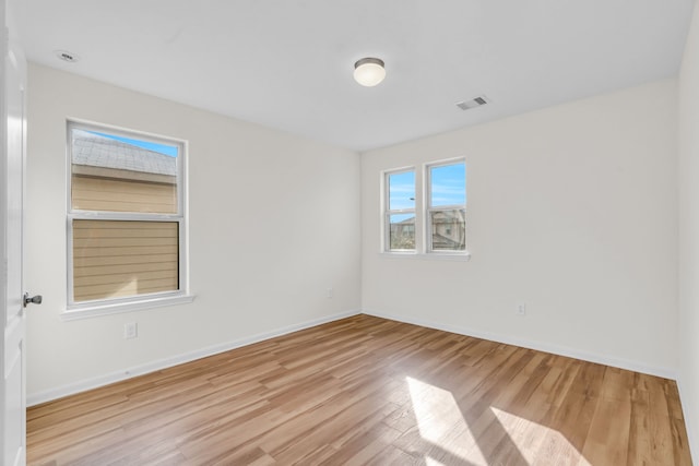 spare room with light hardwood / wood-style floors