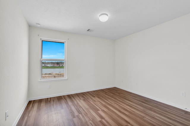 empty room featuring hardwood / wood-style flooring