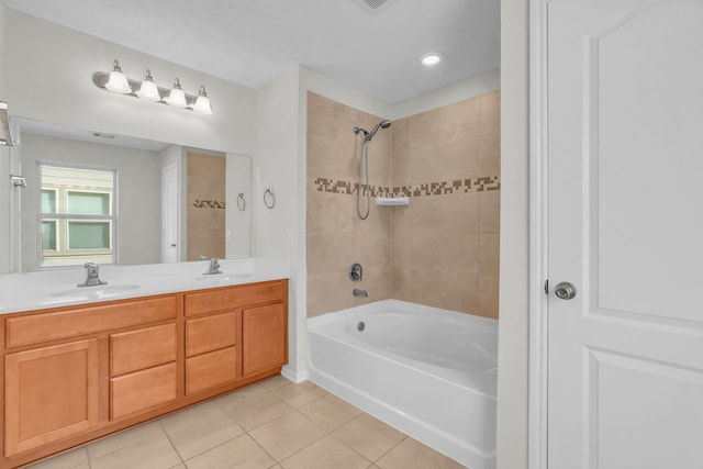 bathroom with tiled shower / bath, tile patterned floors, and vanity