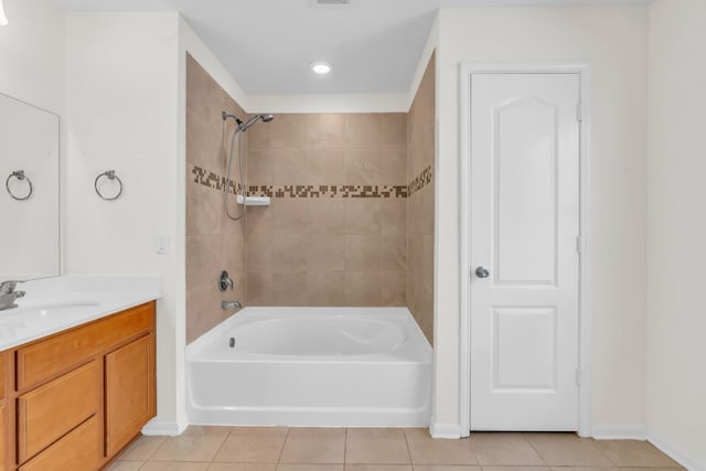 bathroom featuring tile patterned flooring, vanity, and tiled shower / bath combo