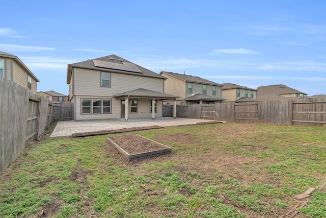 rear view of house featuring a patio area and a lawn