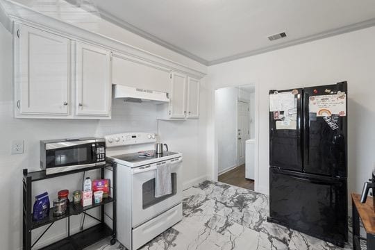 kitchen with black refrigerator, white range with electric cooktop, white cabinetry, and crown molding