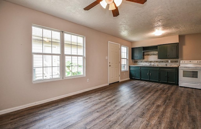 kitchen featuring dark wood-type flooring, white electric range oven, sink, and a textured ceiling