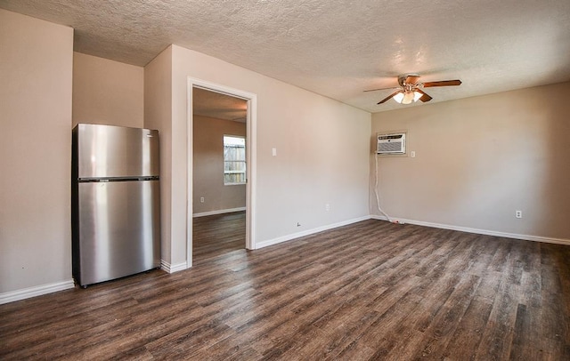 interior space with ceiling fan, an AC wall unit, a textured ceiling, and dark hardwood / wood-style flooring