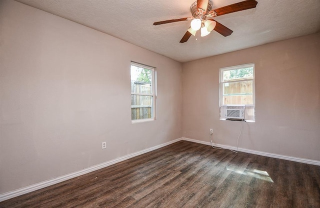 empty room with ceiling fan, dark hardwood / wood-style flooring, and a textured ceiling