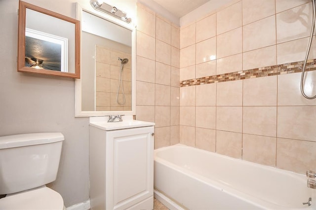 full bathroom with vanity, tiled shower / bath, and toilet