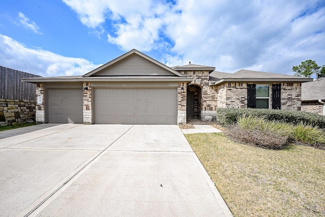 view of front of home featuring a garage and a front yard