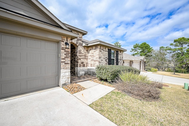 property entrance featuring a yard and a garage