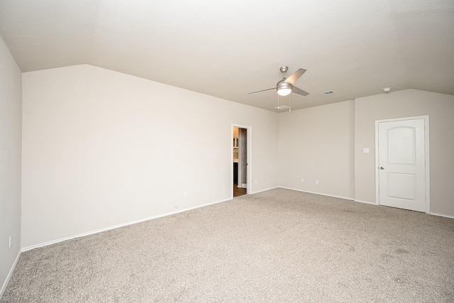 spare room with lofted ceiling, carpet floors, and ceiling fan