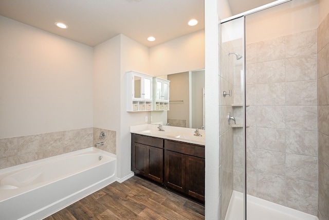 bathroom with vanity, wood-type flooring, and independent shower and bath