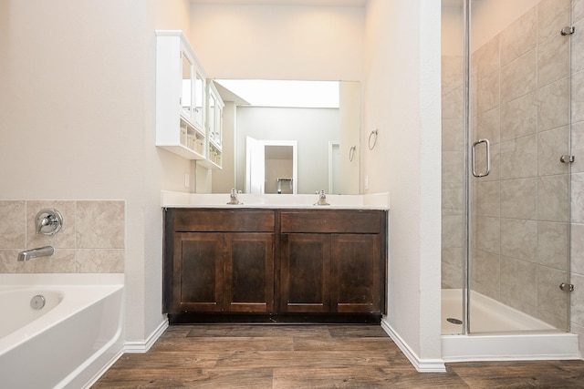 bathroom with vanity, independent shower and bath, and hardwood / wood-style floors