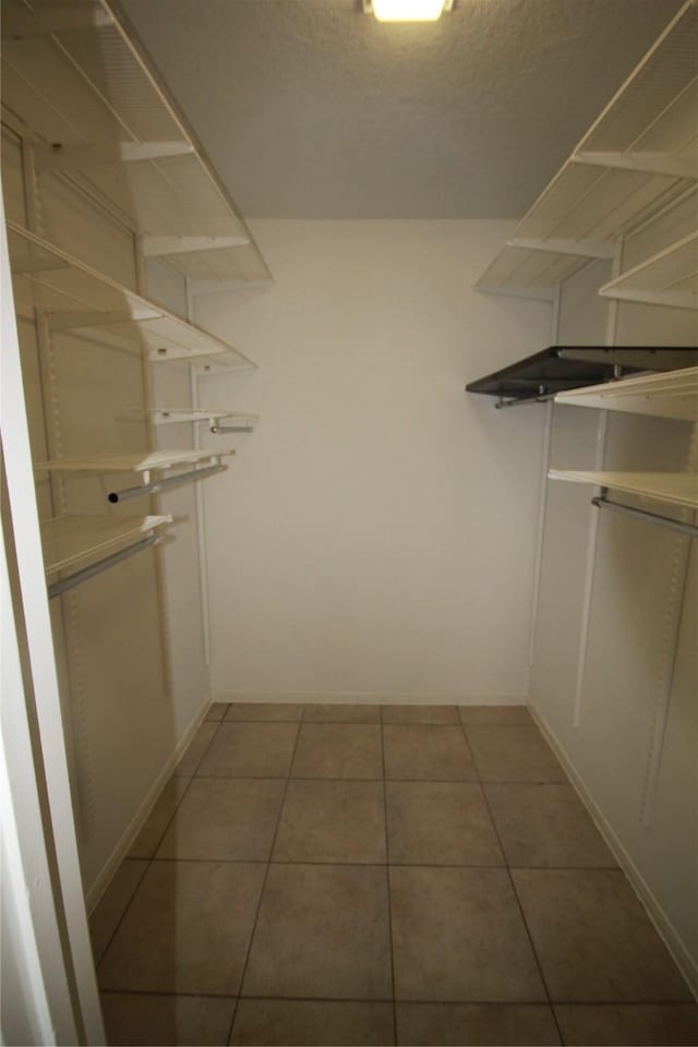 walk in closet featuring light tile patterned flooring