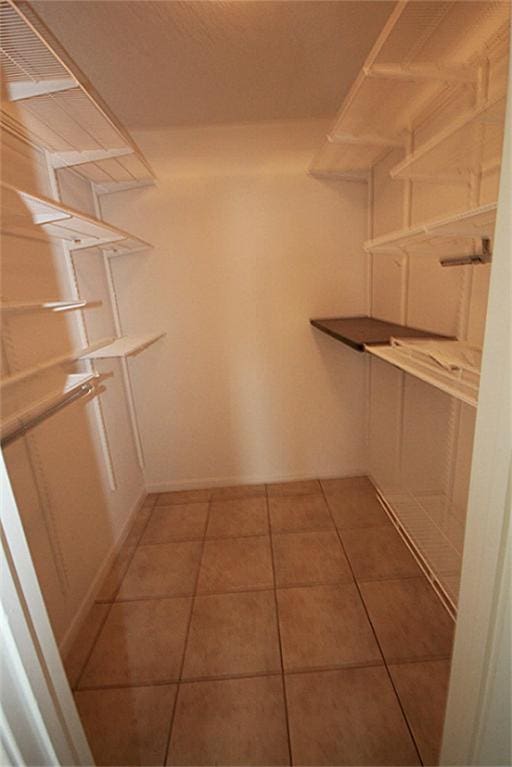 walk in closet featuring tile patterned flooring