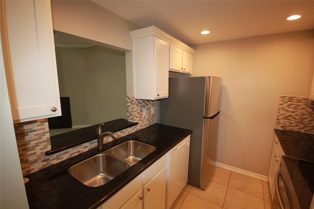 kitchen with stove, white dishwasher, sink, and white cabinets