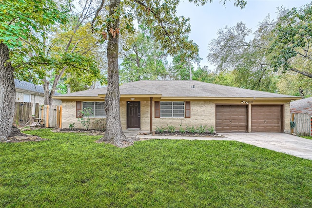 ranch-style home featuring a garage and a front yard