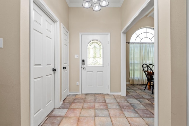 foyer featuring ornamental molding and a chandelier