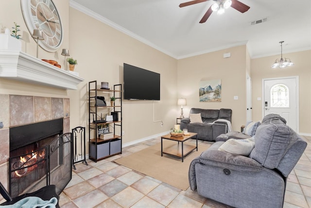 living room featuring ornamental molding, ceiling fan with notable chandelier, and a fireplace