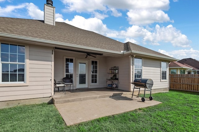 rear view of house featuring a yard, a patio, and ceiling fan