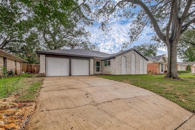 ranch-style home featuring a garage and a front yard