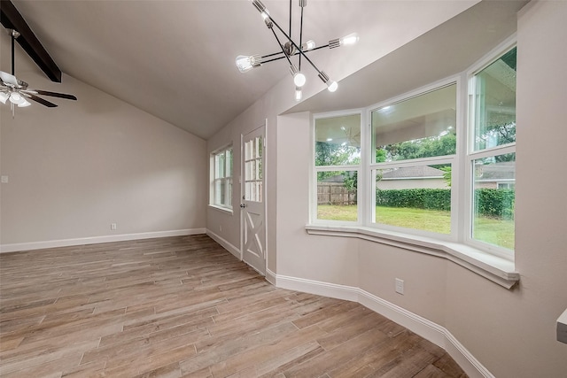 unfurnished room with lofted ceiling with beams, ceiling fan with notable chandelier, and light hardwood / wood-style floors