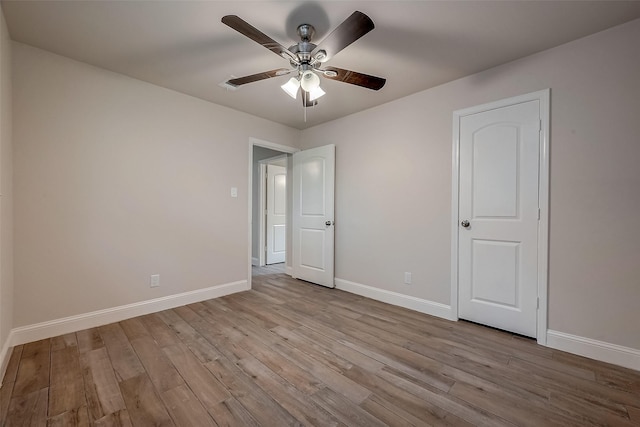 unfurnished bedroom with ceiling fan and light hardwood / wood-style flooring