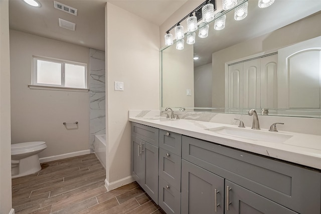 full bathroom featuring shower / bathtub combination, vanity, and toilet