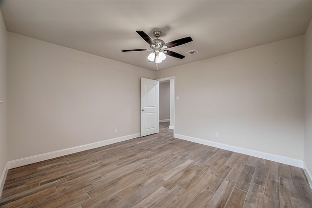 empty room featuring ceiling fan and light hardwood / wood-style floors