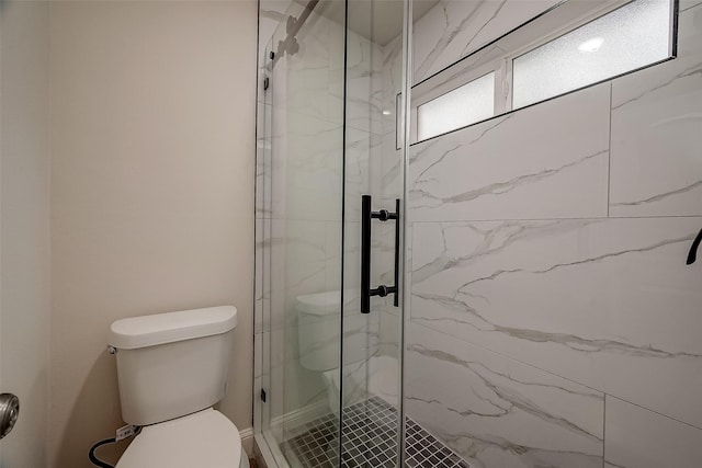 bathroom with an enclosed shower and toilet