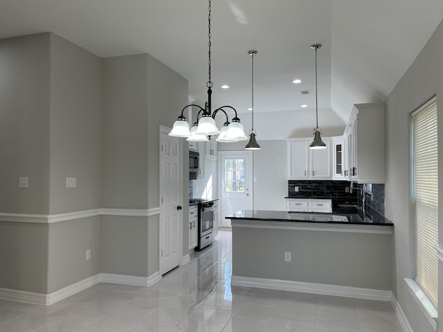 kitchen featuring appliances with stainless steel finishes, decorative light fixtures, sink, white cabinets, and decorative backsplash