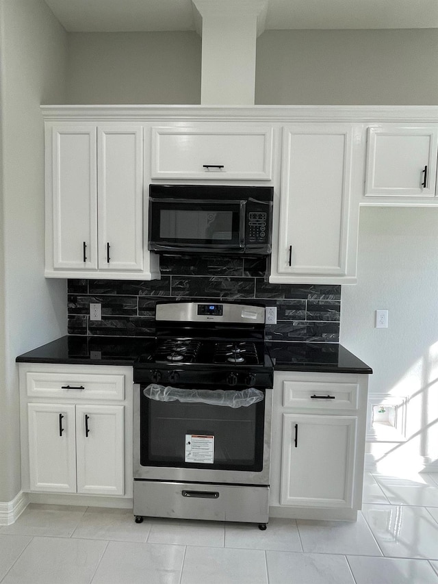 kitchen featuring white cabinetry, stainless steel range with gas cooktop, and backsplash