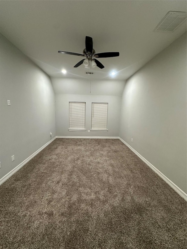 carpeted empty room featuring ceiling fan and vaulted ceiling