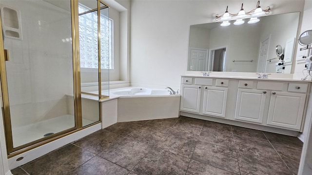 bathroom with a sink, double vanity, a garden tub, and a shower stall