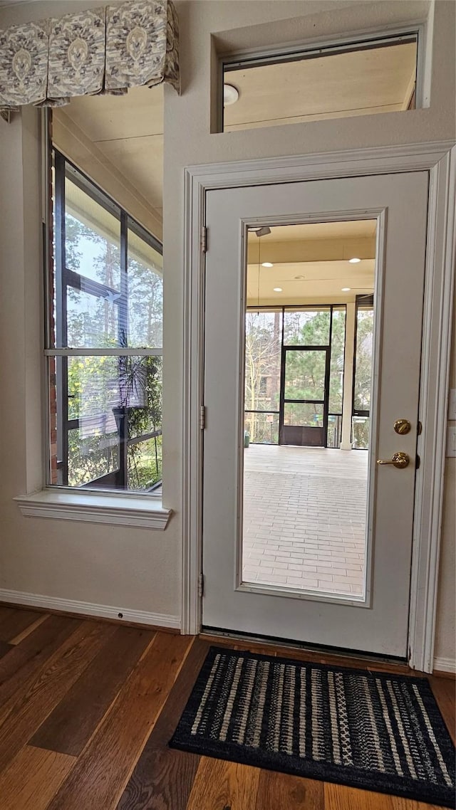 entryway featuring baseboards and dark wood finished floors