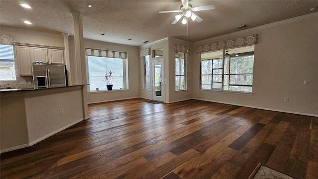 unfurnished living room with dark wood-style floors, crown molding, ceiling fan, and baseboards