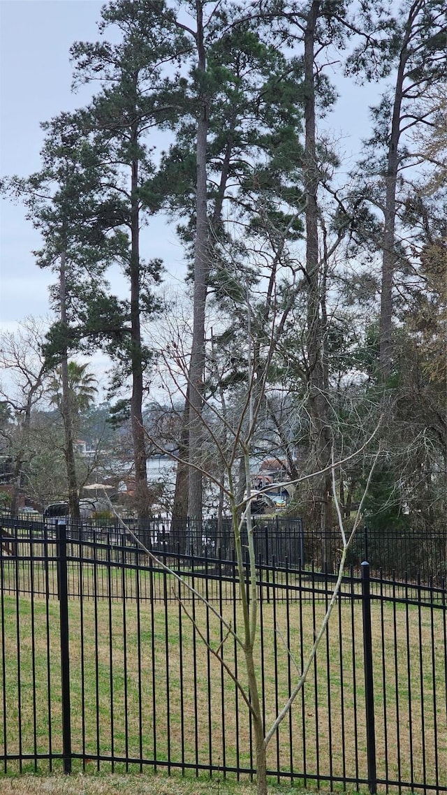 view of yard with basketball court and fence