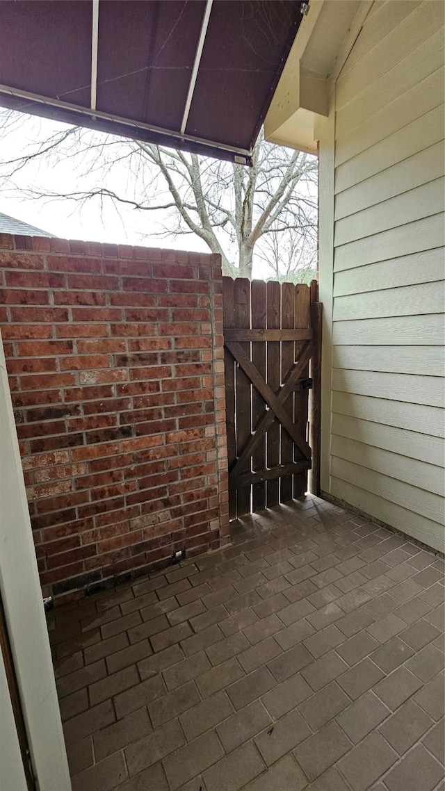 view of patio featuring a gate