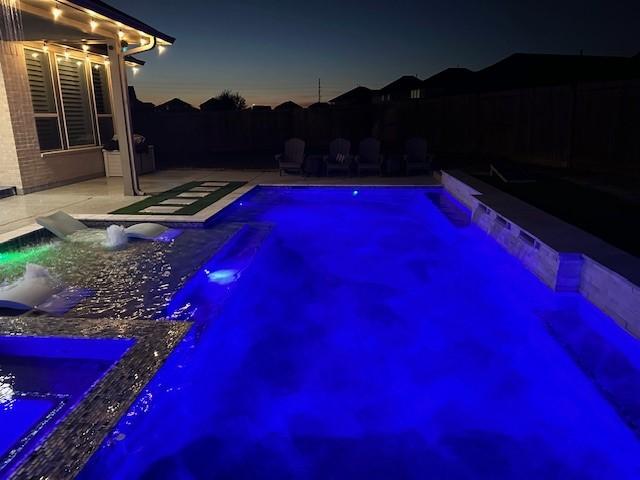 view of pool with a patio and pool water feature