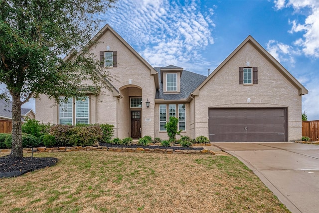 front of property with a garage and a front lawn