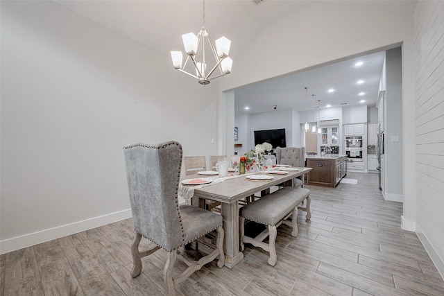 dining room with an inviting chandelier and light hardwood / wood-style floors