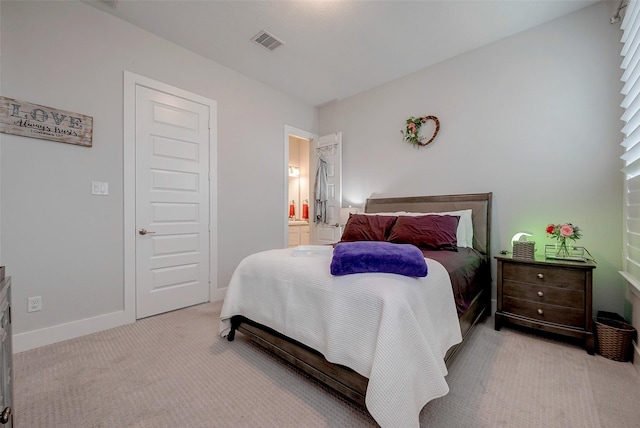 carpeted bedroom featuring ensuite bathroom